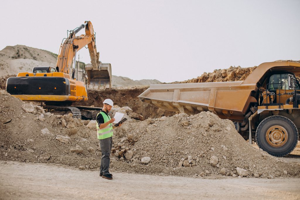 Servicios male worker with bulldozer in sand quarry